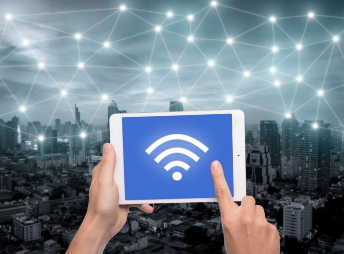 hand-holding-tablet-with-wifi-icon-on-city-and-network-connection-concept--bangkok-smart-city-and-wireless-communication-network--abstract-image-visual--internet-of-things--627698790-593f28255f9b58d58add7427.jpg