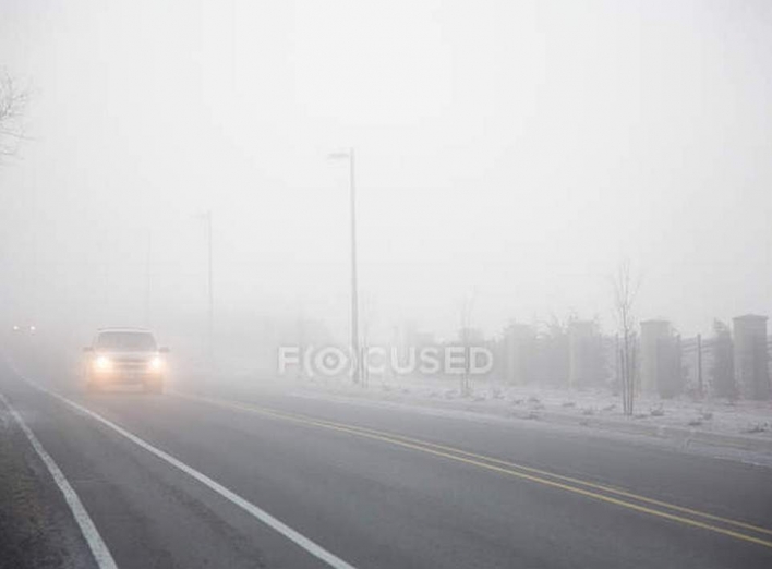 focused_165289150-stock-photo-fog-road-moving-car.jpg